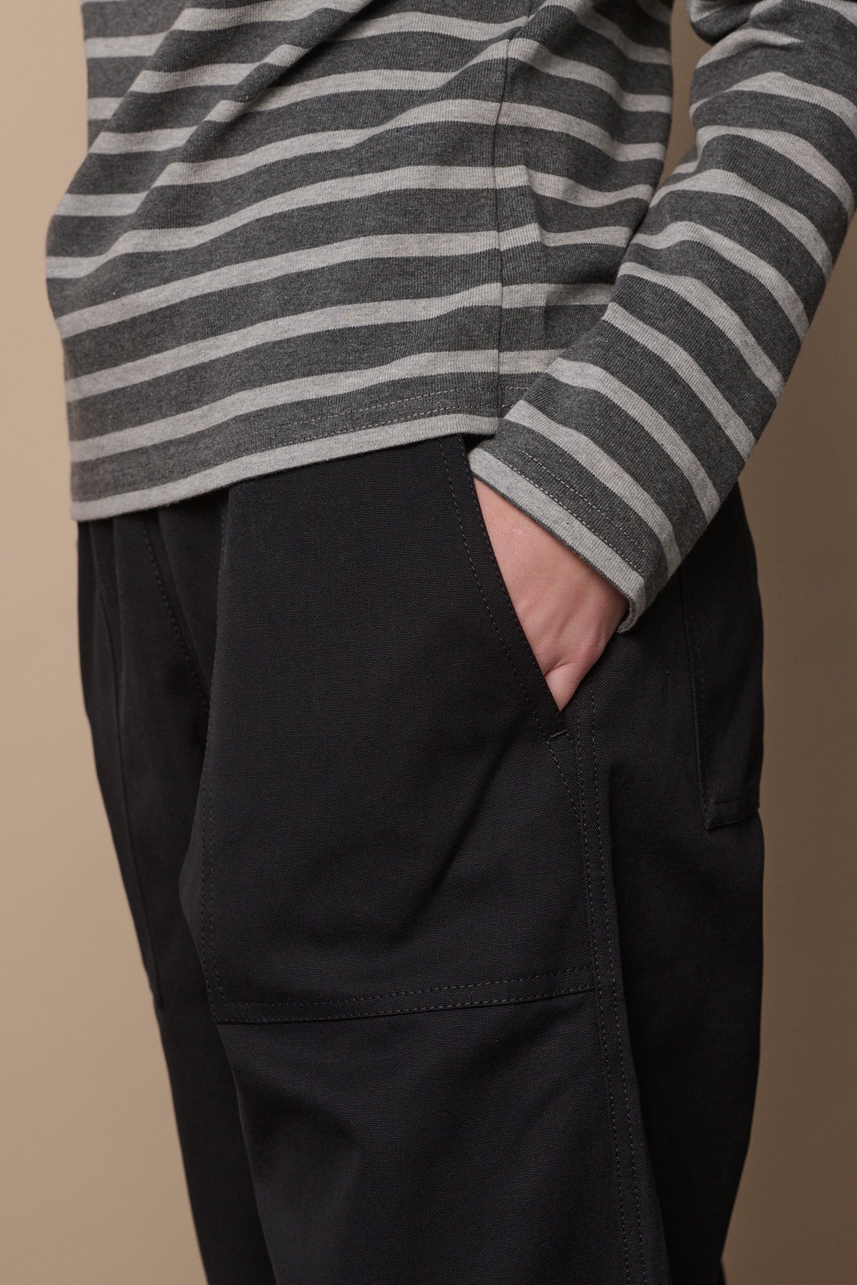 
            Front pocket detail of camerawoman cotton trousers in black