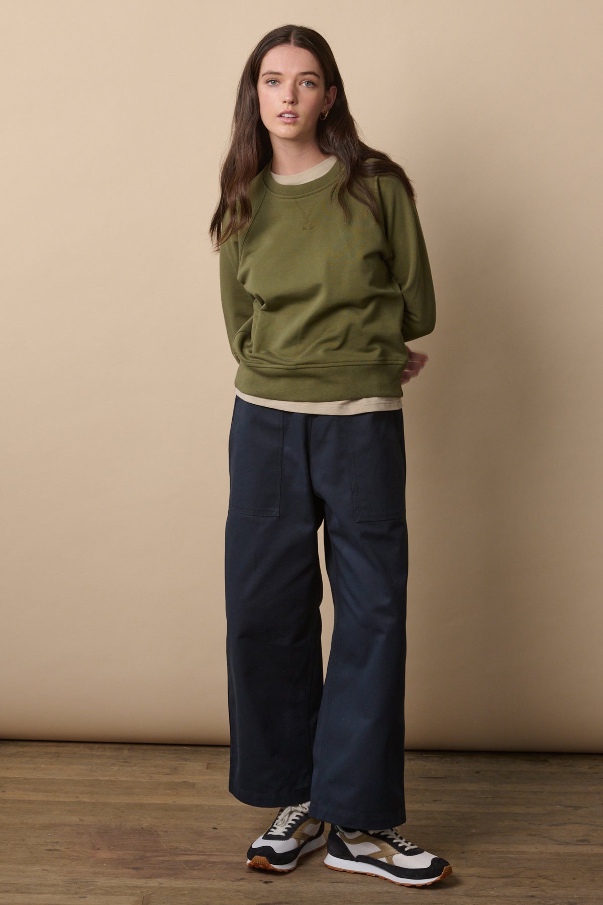 
            Full body image of female with long brunette hair wearing camerawoman trousers