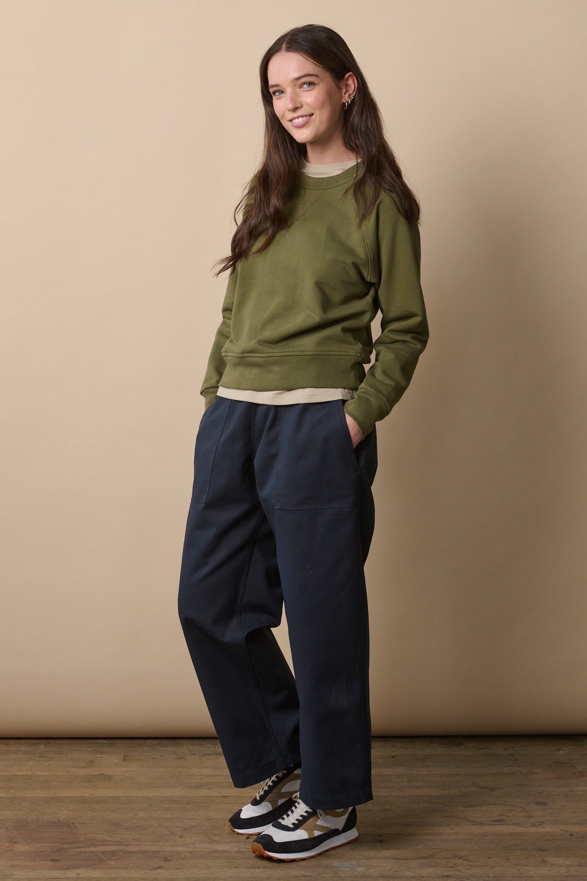 
            Full body image of female with long brunette hair wearing camerawoman trousers