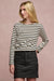 Thigh up image of blonde female wearing Charlie denim mini skirt in black paired with Breton in white black