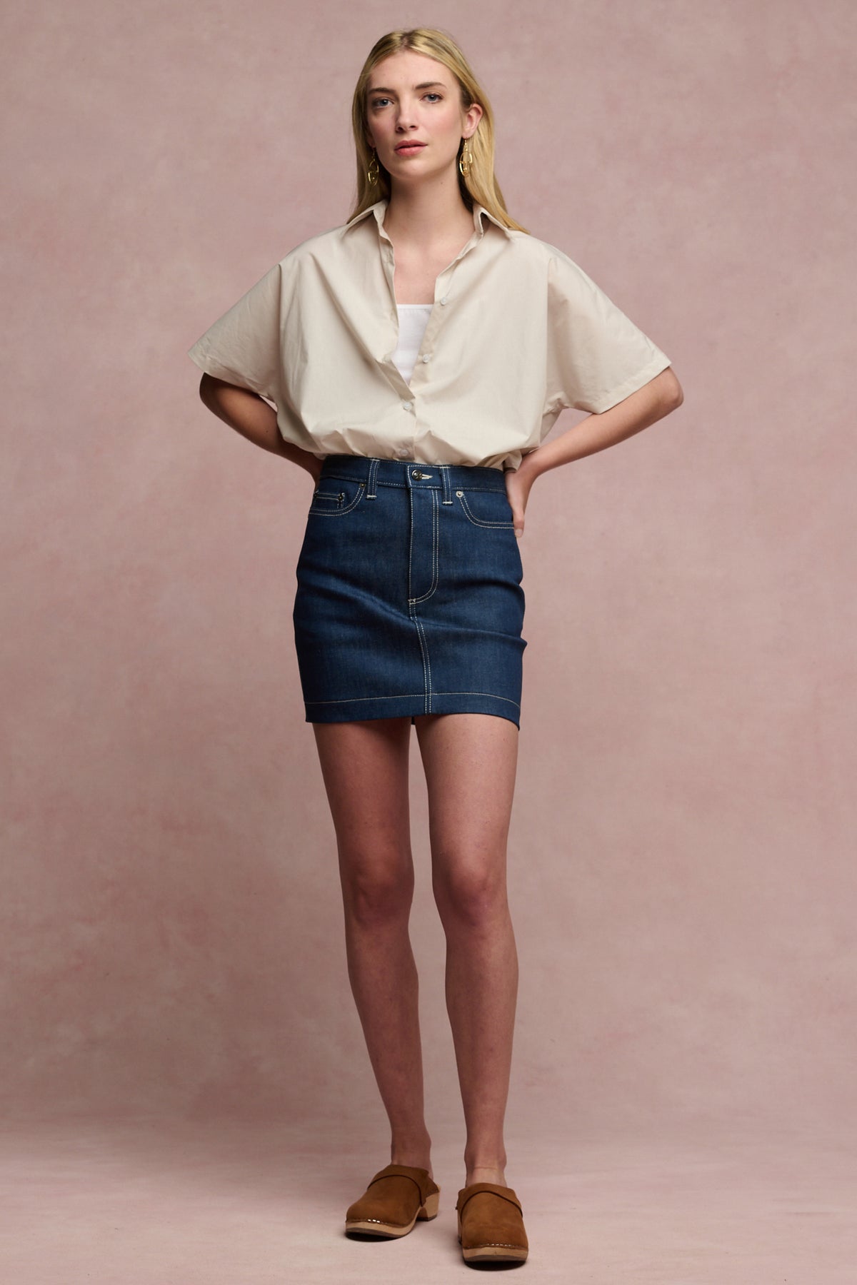 Full body image of female wearing Charlie denim mini skirt in blue with stone Ava shirt