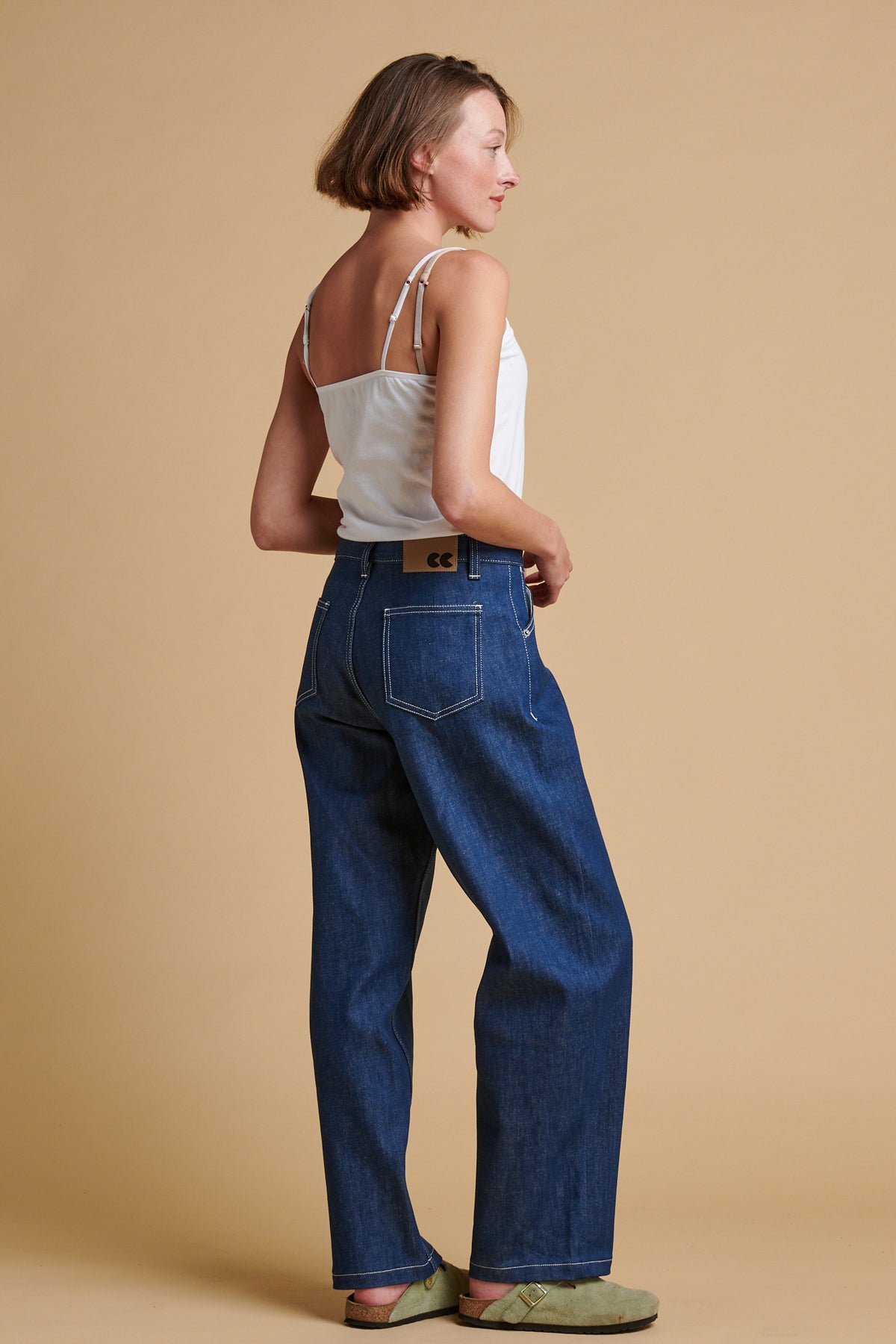 Female wearing chore jeans in blue.