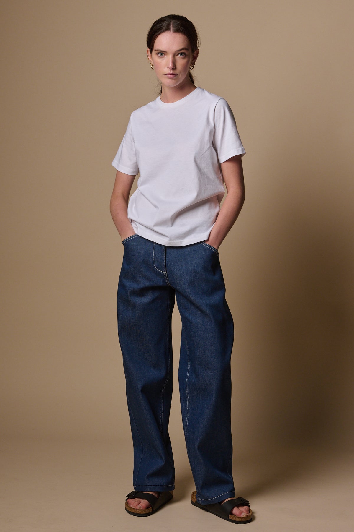 
            Full body image of female wearing chore jeans in blue paired with short sleeve t shirt in white
