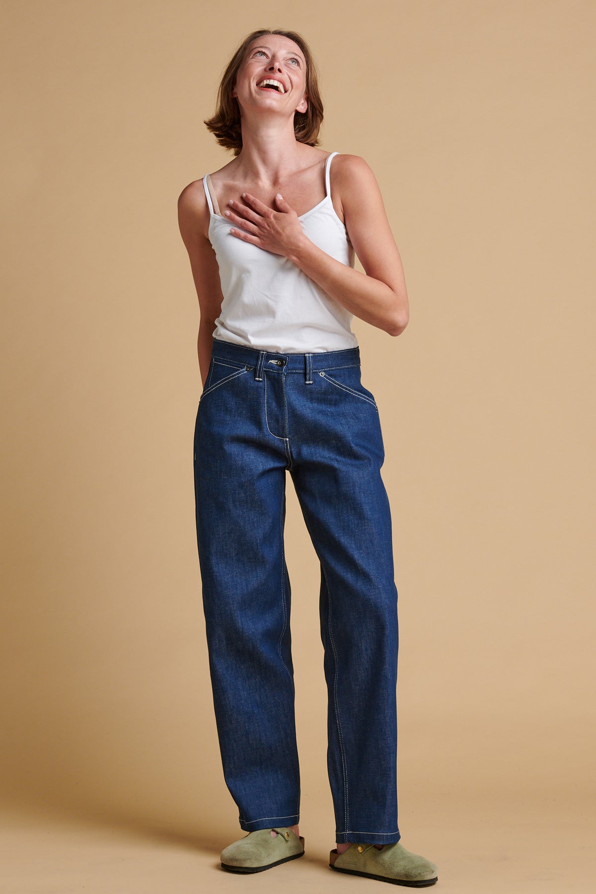 Female wearing chore jeans in blue.