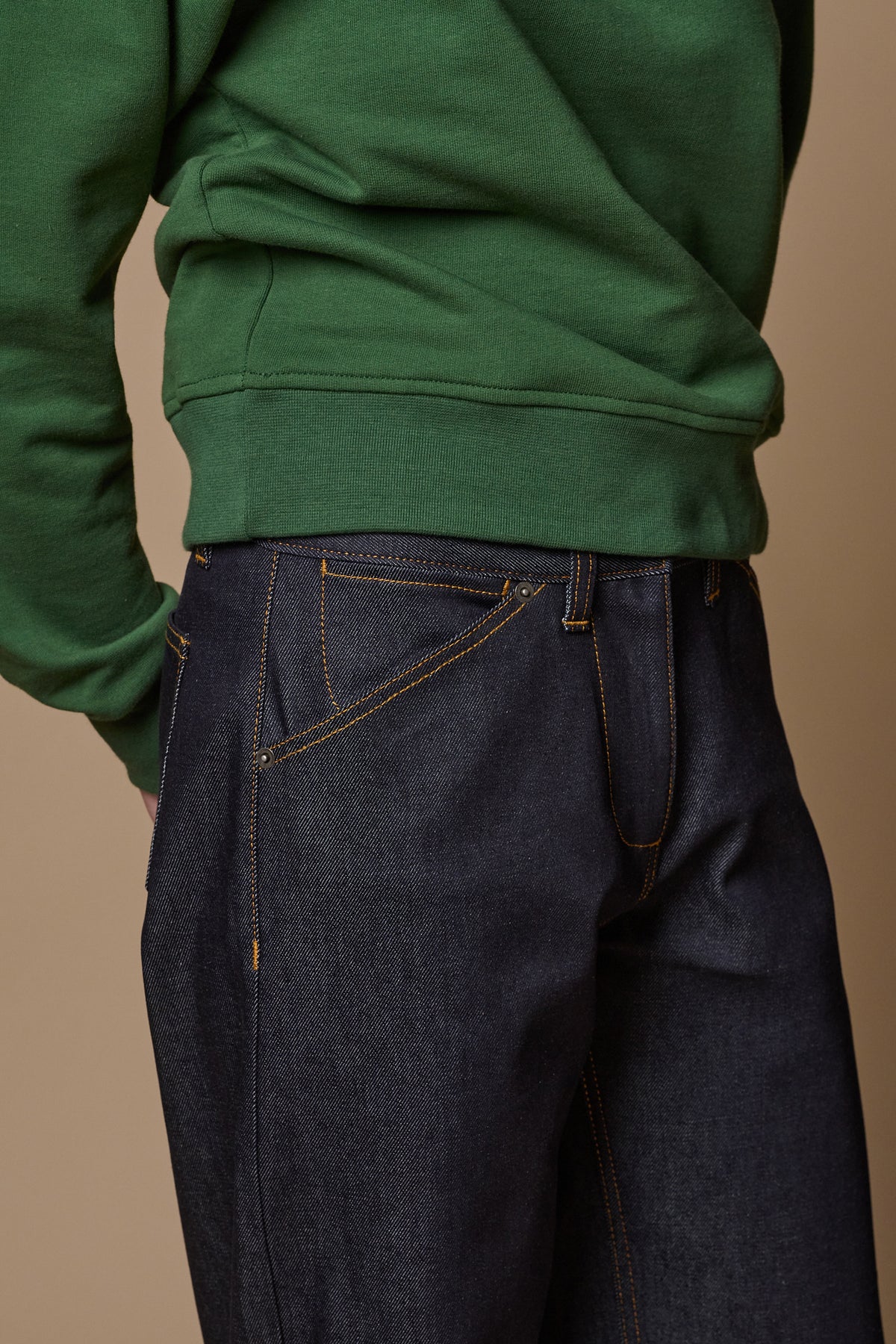 
            Image showing the detail of the front pockets and coin pocket. Orange sticthing