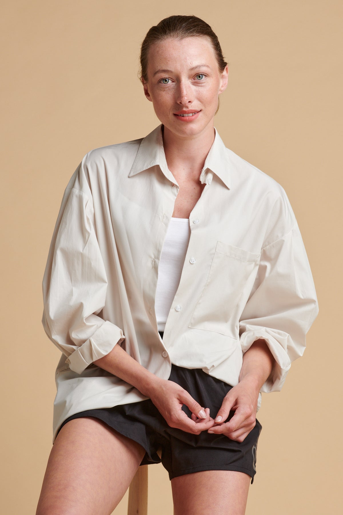 Female wearing long sleeve Esme shirt in stone.