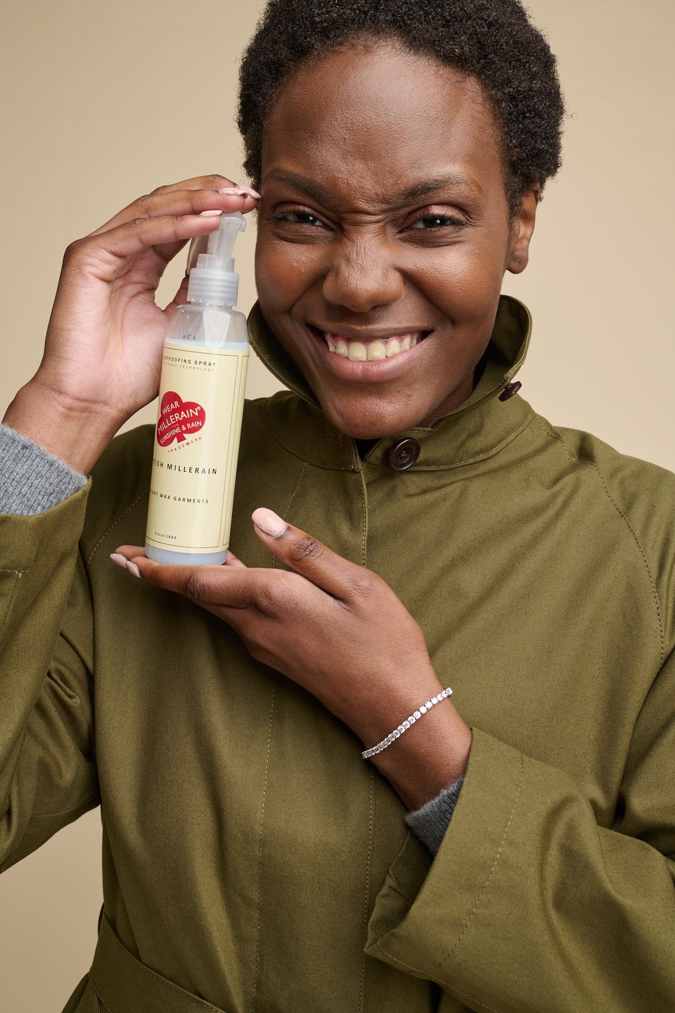 Image of smiley black female holing staywax re-wax spray