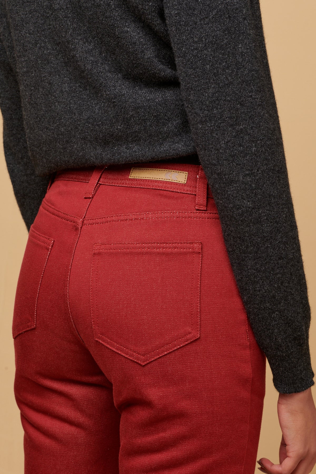 The back of women's Gloria Jean with two back pockets CC logo jeans patch on the waistband with belt loops.