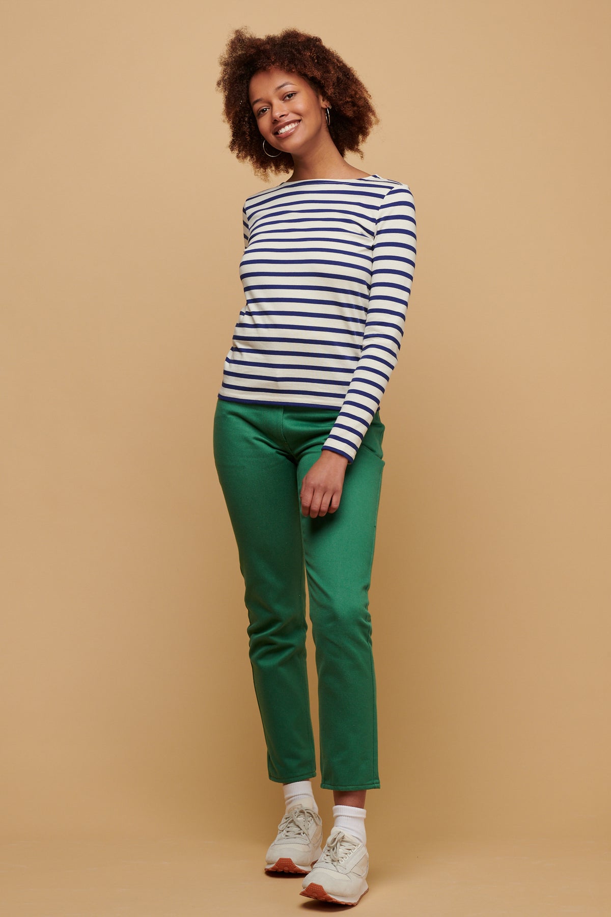 Smiley female wearing Breton in bright blue/ ecru paired with Gloria jean in green