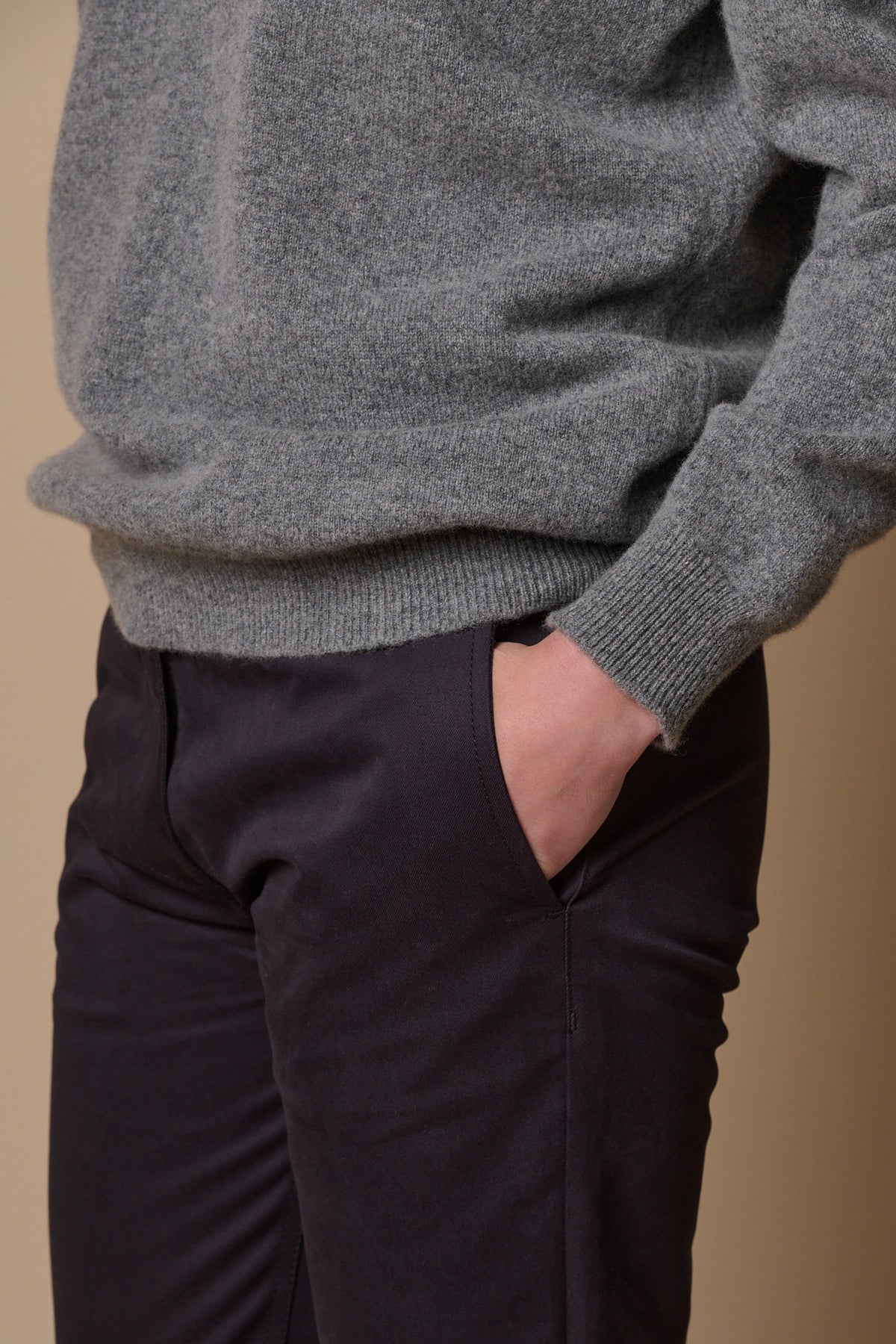 close up shot of female with hand in front pocket of heavyweight slim chino in navy