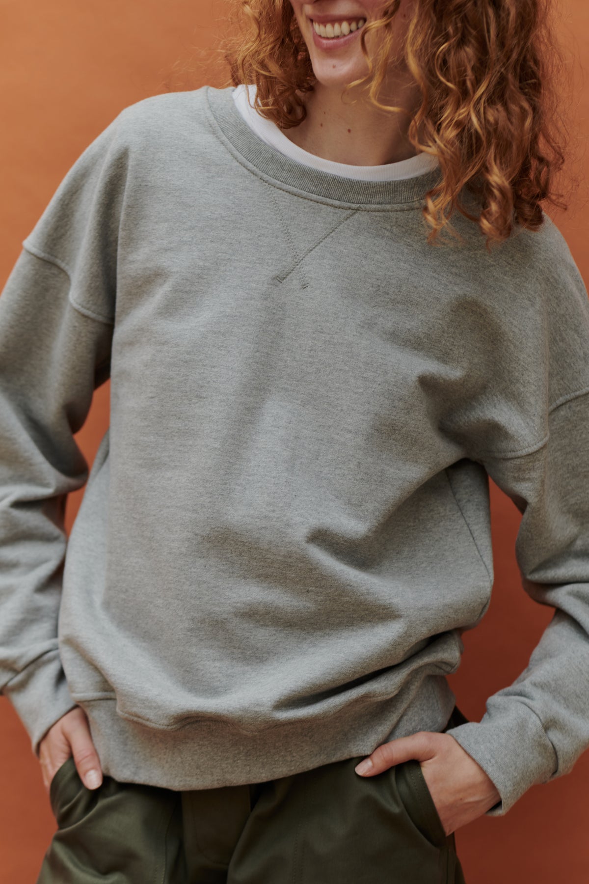 
            Female wearing heritage sweatshirt in grey