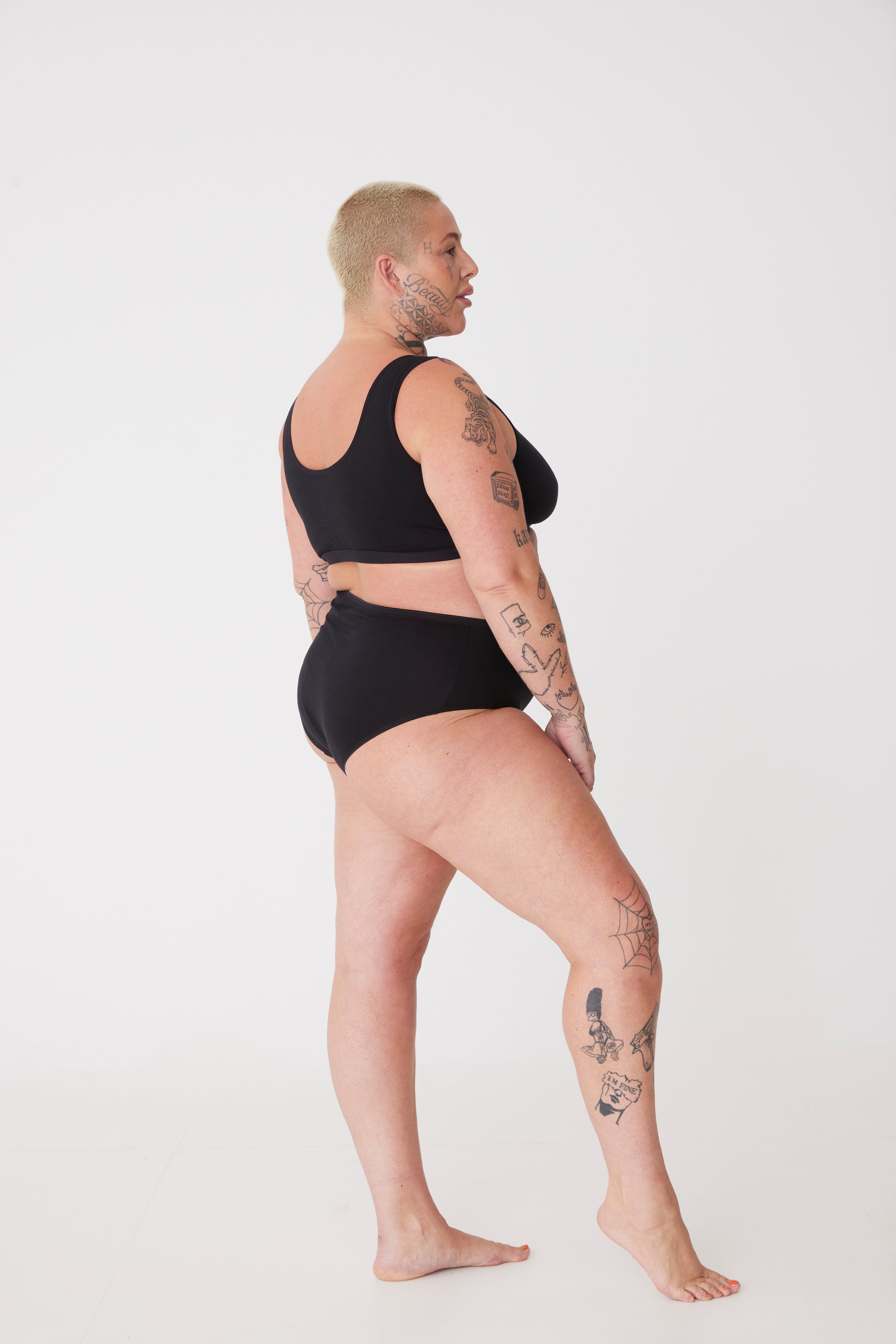 tattooed, plus size, white female in black high rise brief 