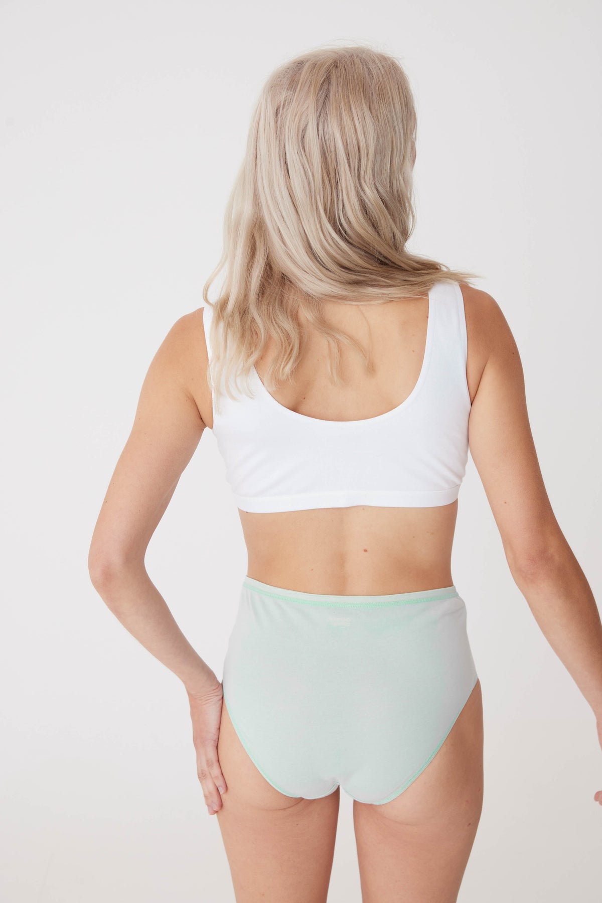 blonde, white female wearing high rise brief in sage