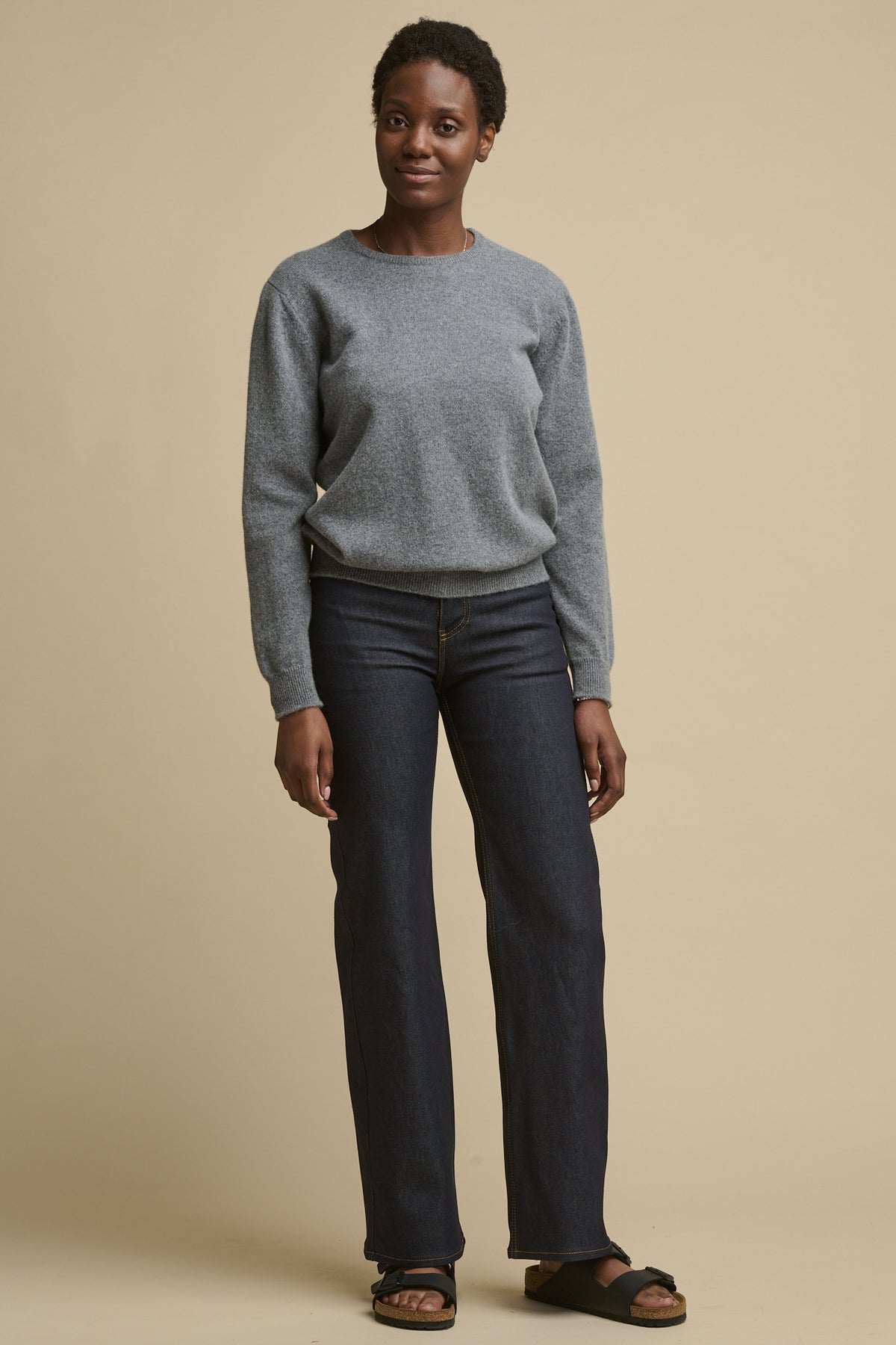 
            Full body image of the front of female wearing high rise wide leg jeans in indigo paired with lambswool crew neck