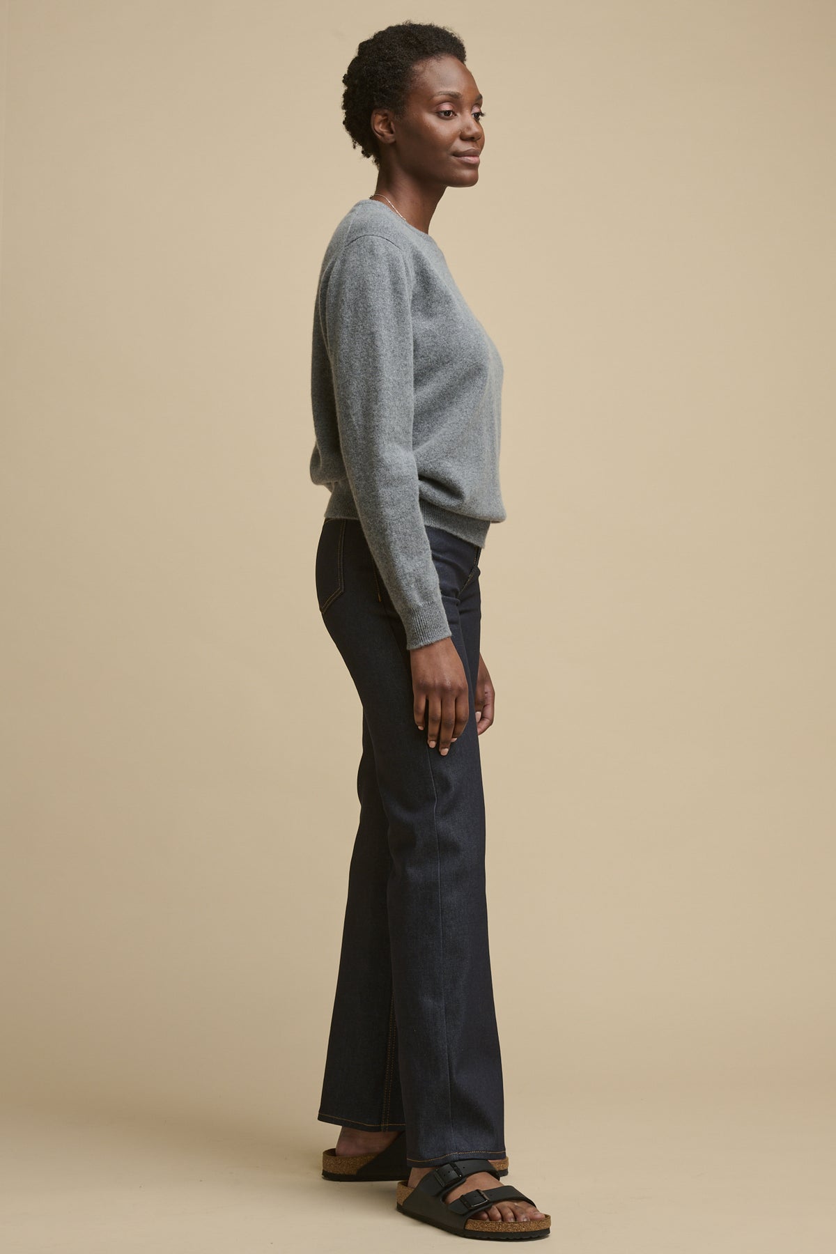 
            Full body image of the side of female wearing high rise wide leg jeans in indigo