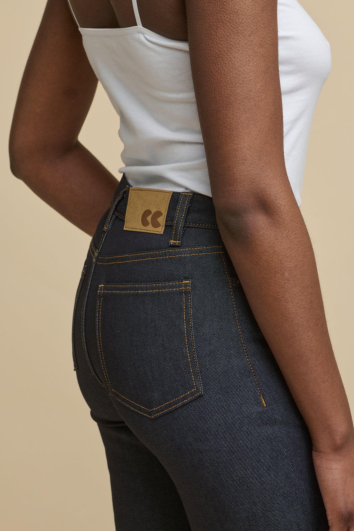 
            Close up image of the back waistband and pocket details. CC logo jeans patch on the back of the waistband with belt loops