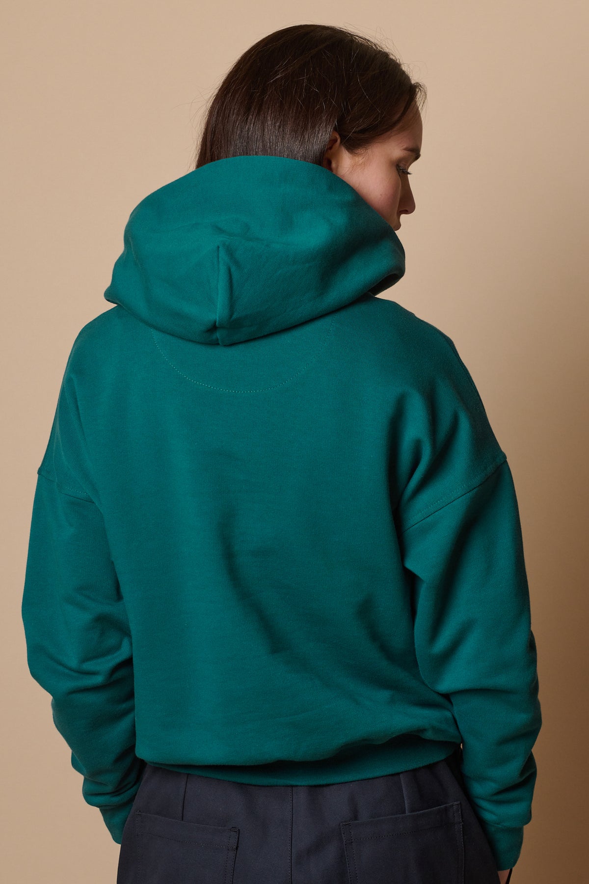 Back of hooded sweatshirt in teal