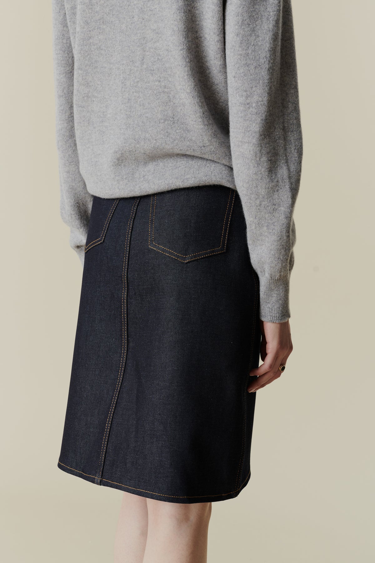 Back of female wearing jean skirt in indigo