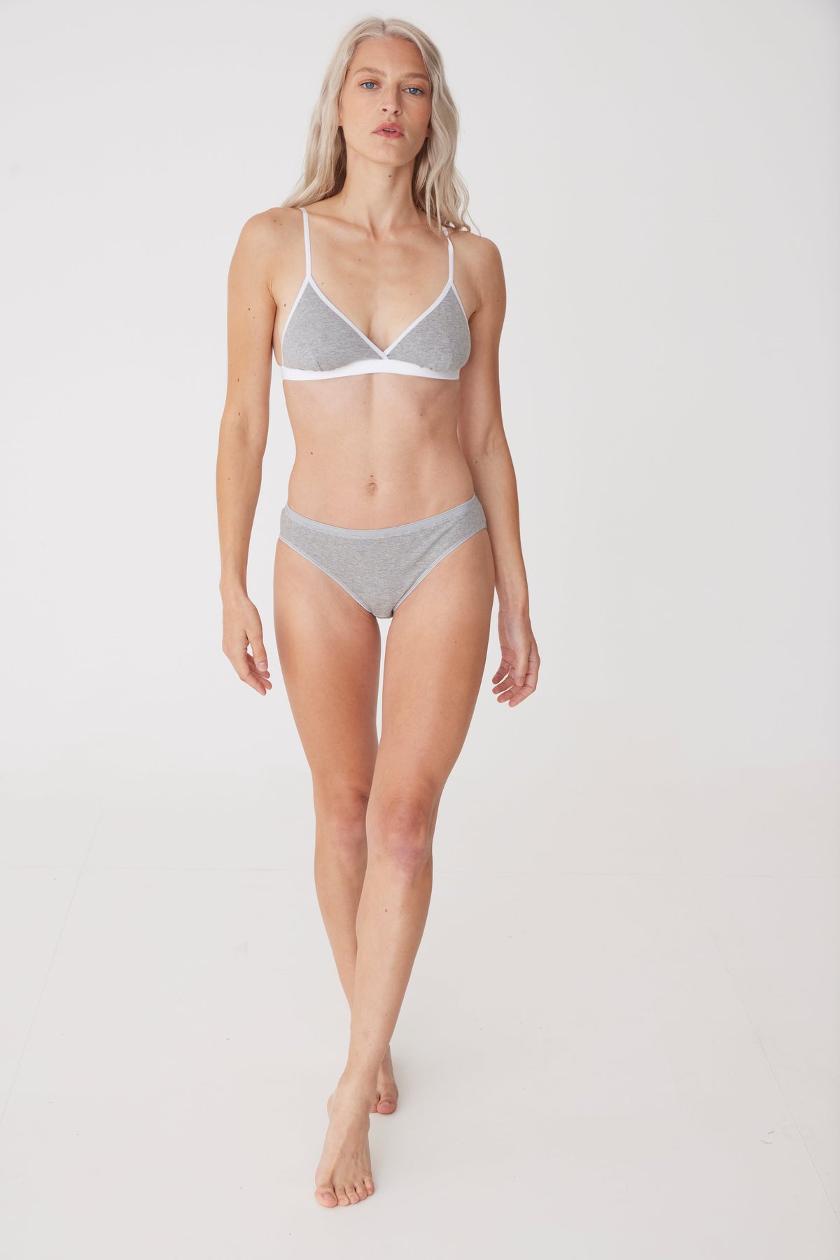 Blonde female wearing grey jersey bralette paired with low rise brief