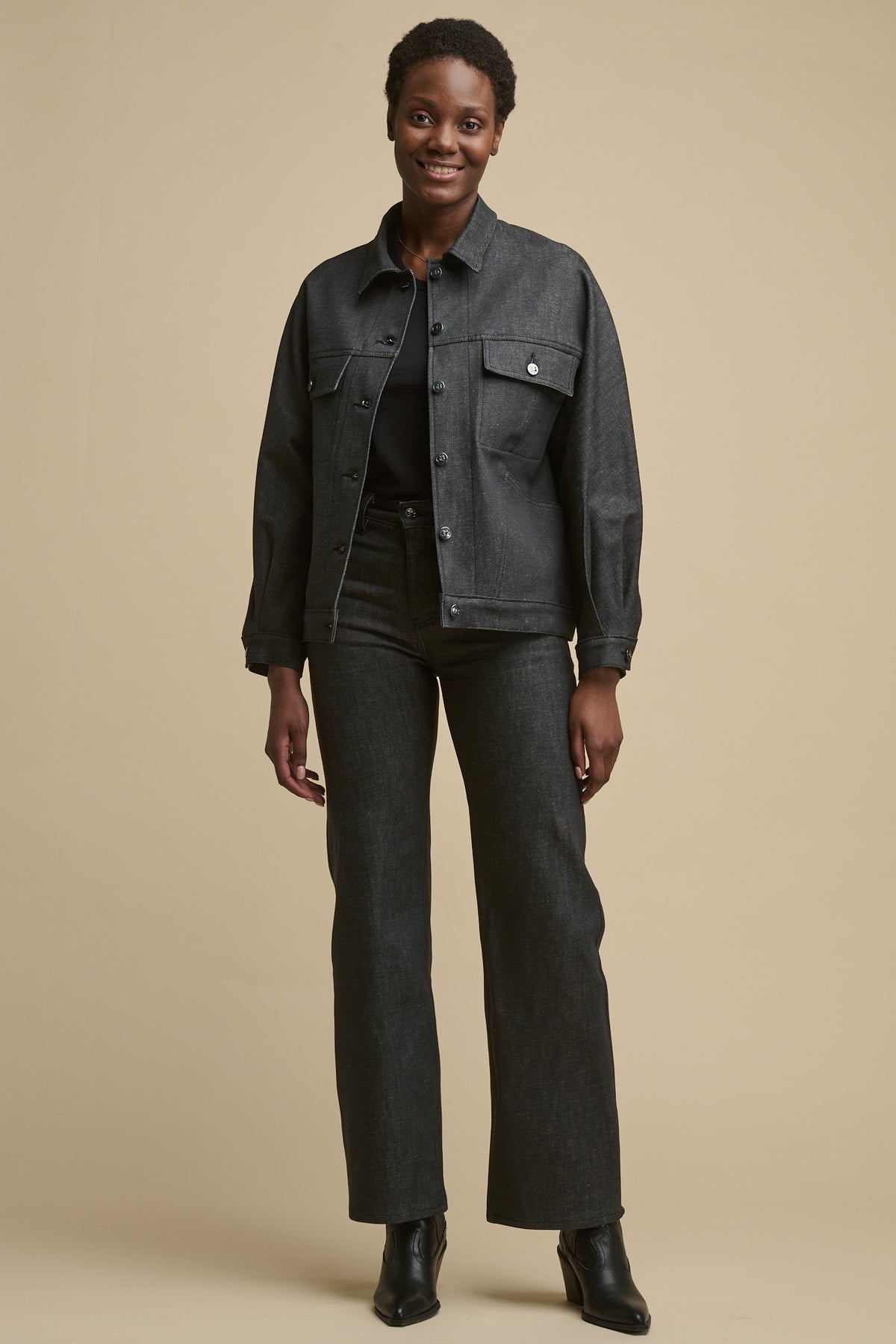 
            Full body image of black female wearing Jodie denim jacket in black paired with matching high rise wide leg jeans 