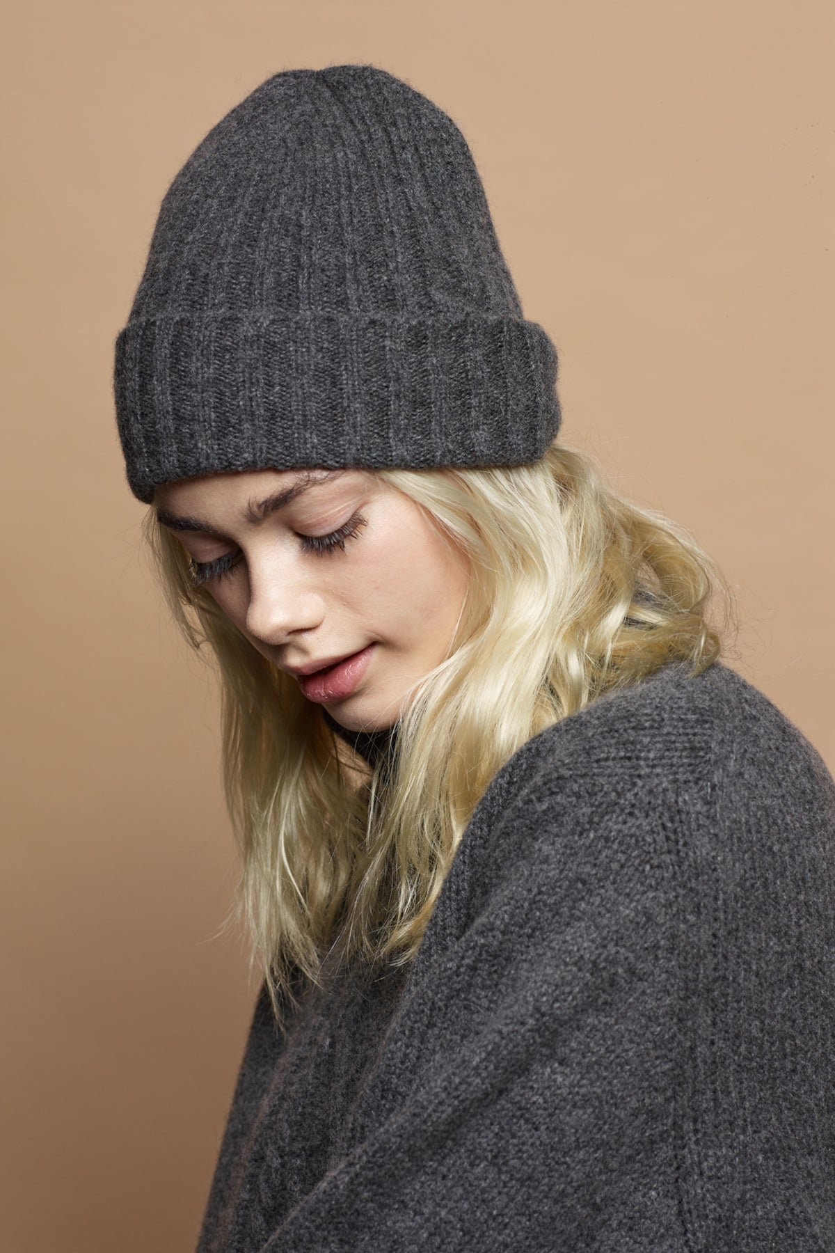
            Side portrait image of blonde female wearing unisex lambswool beanie hat