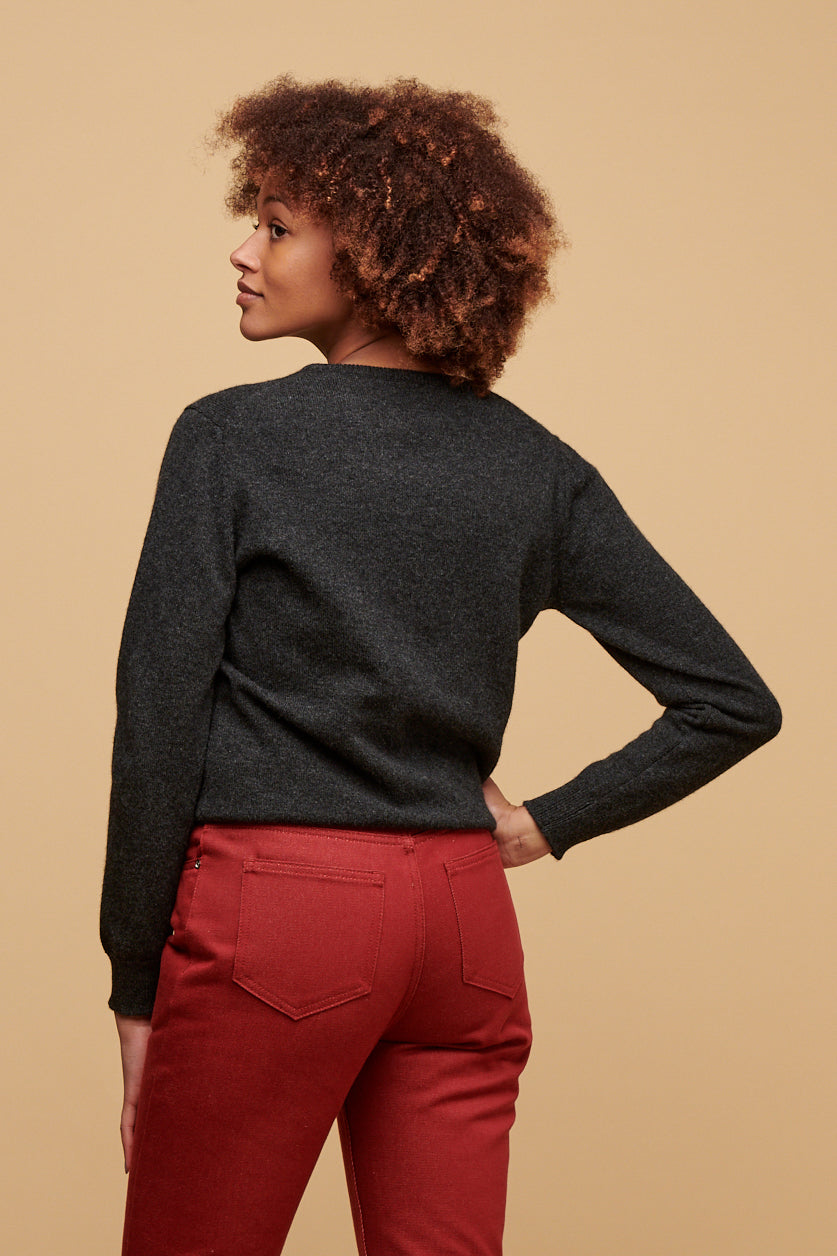 
            Thigh up image of the back of female wearing lambswool crew neck jumper in charcoal paired with Gloria jeans in burgundy