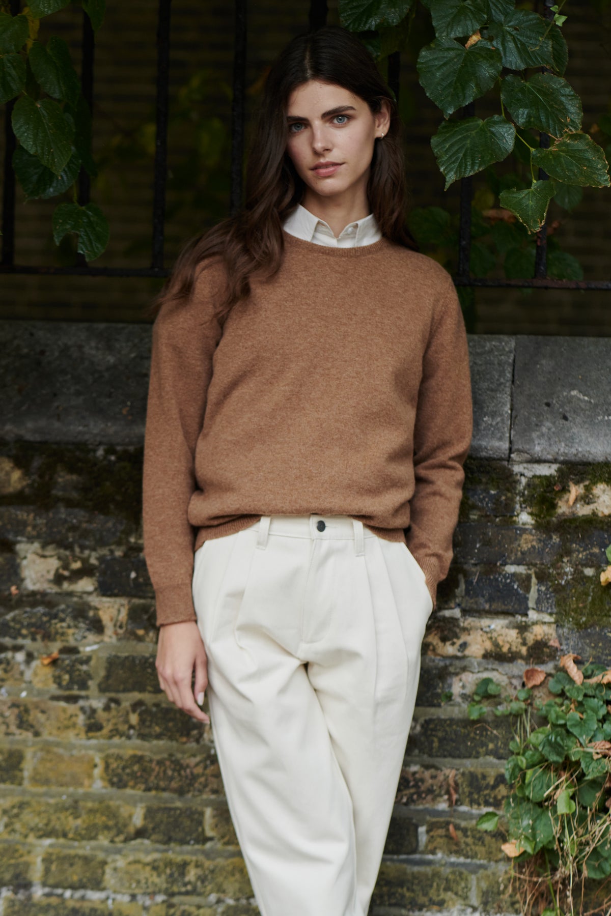 Brunnette female wearing lambswool crew neck in dark camel