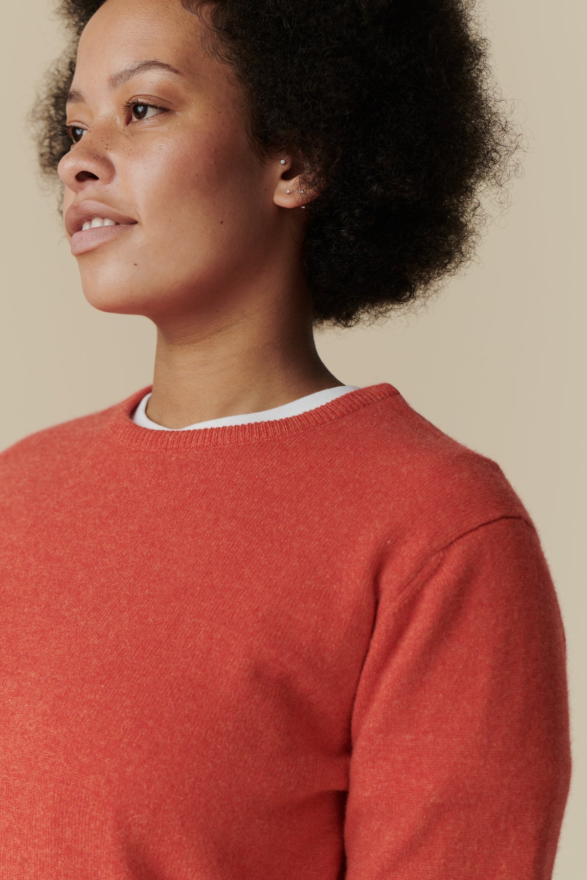 female wearing lambswool crew neck in flame red