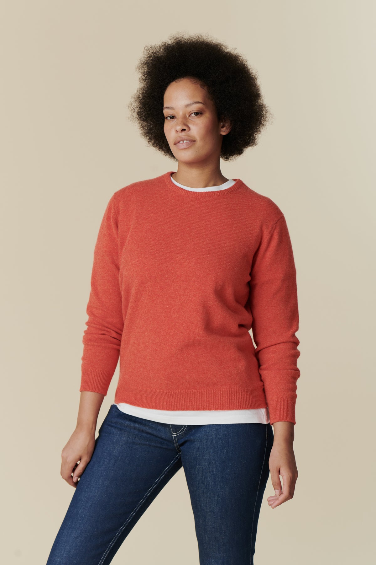 
            Knee up image of female wearing lambswool crew neck in flame red