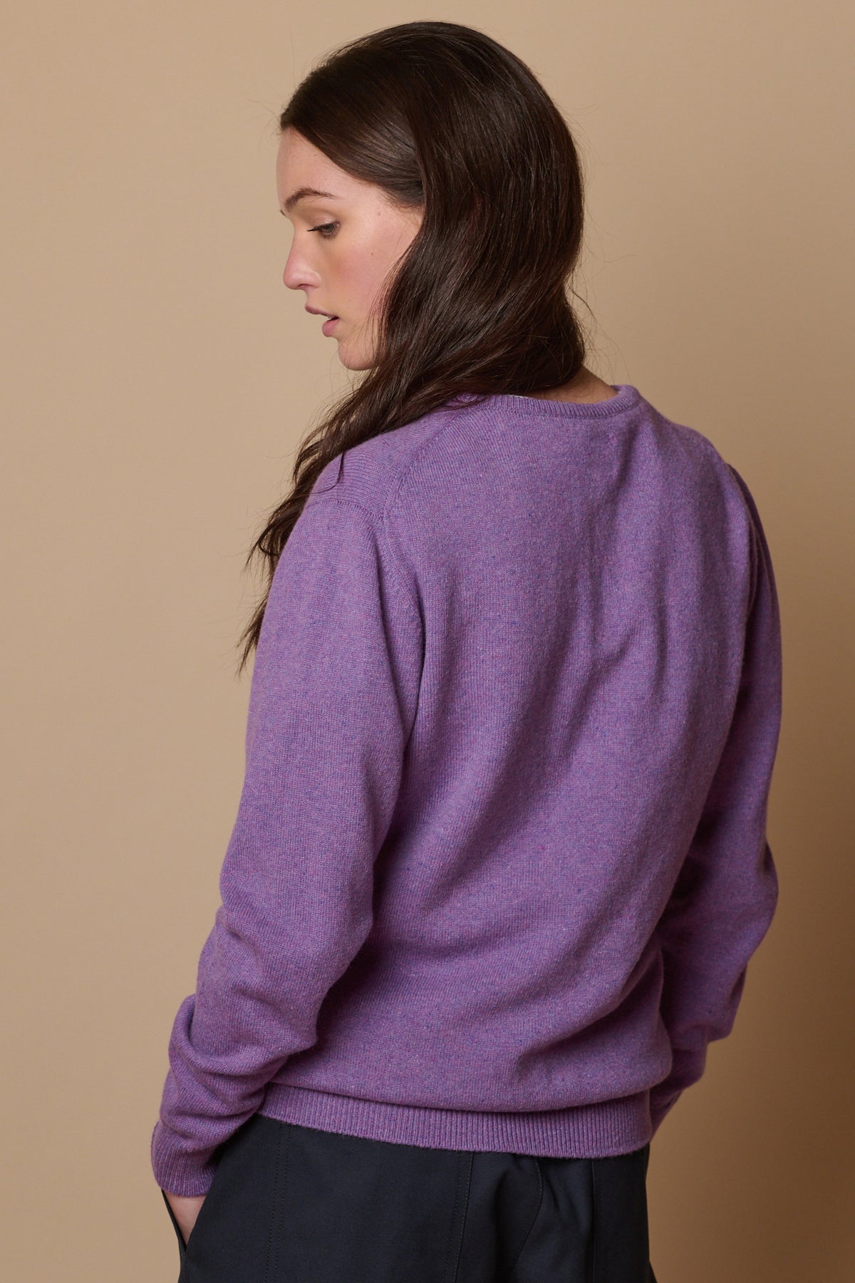 Back of female wearing lambswool crew neck thistle purple