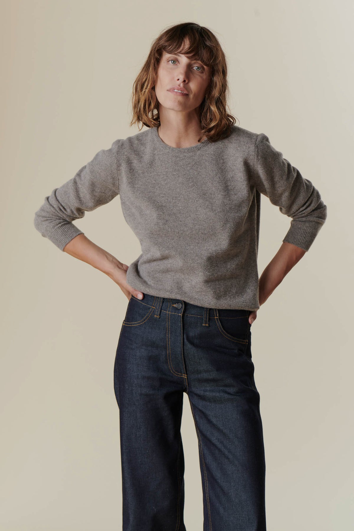 
            Brunette female wearing lambswool crew neck in truffle