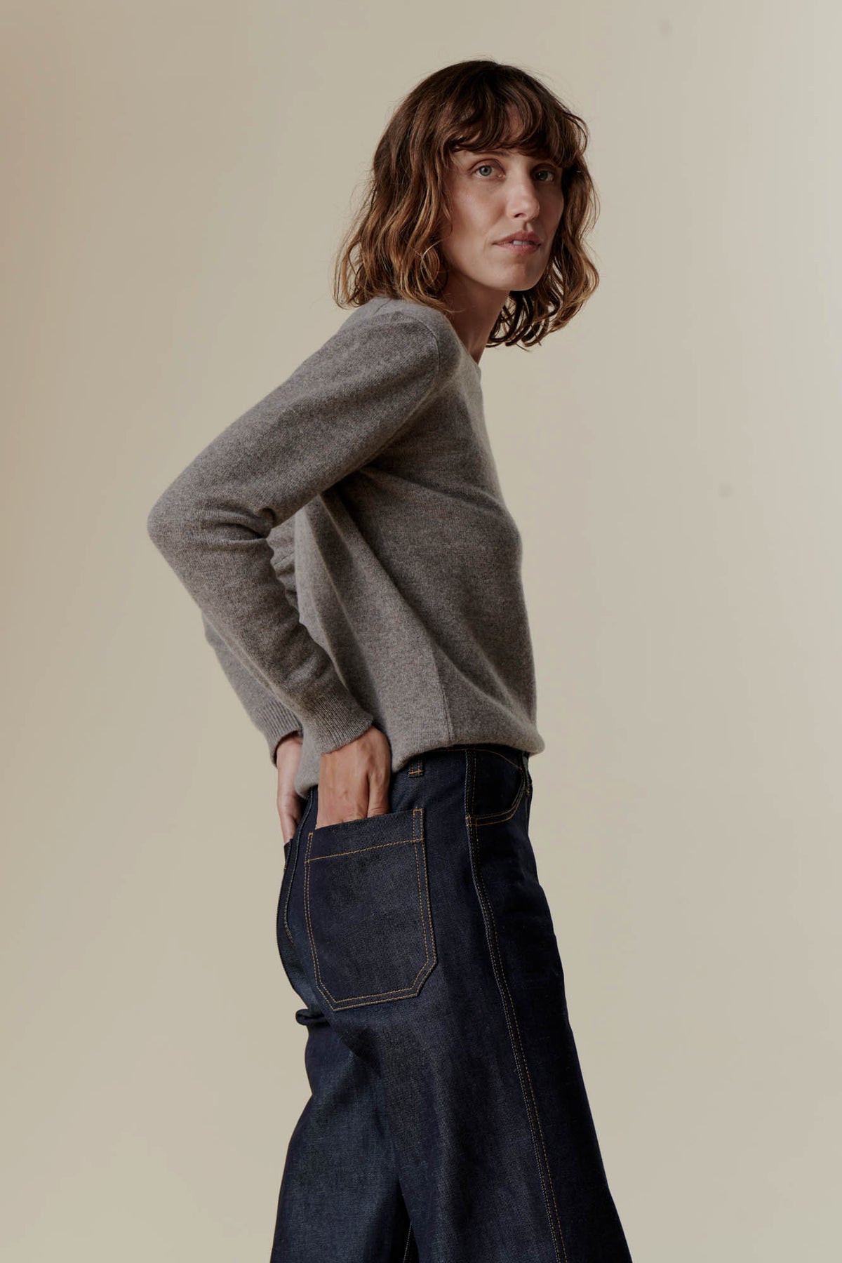 Female wearing lambswool crew neck in truffle