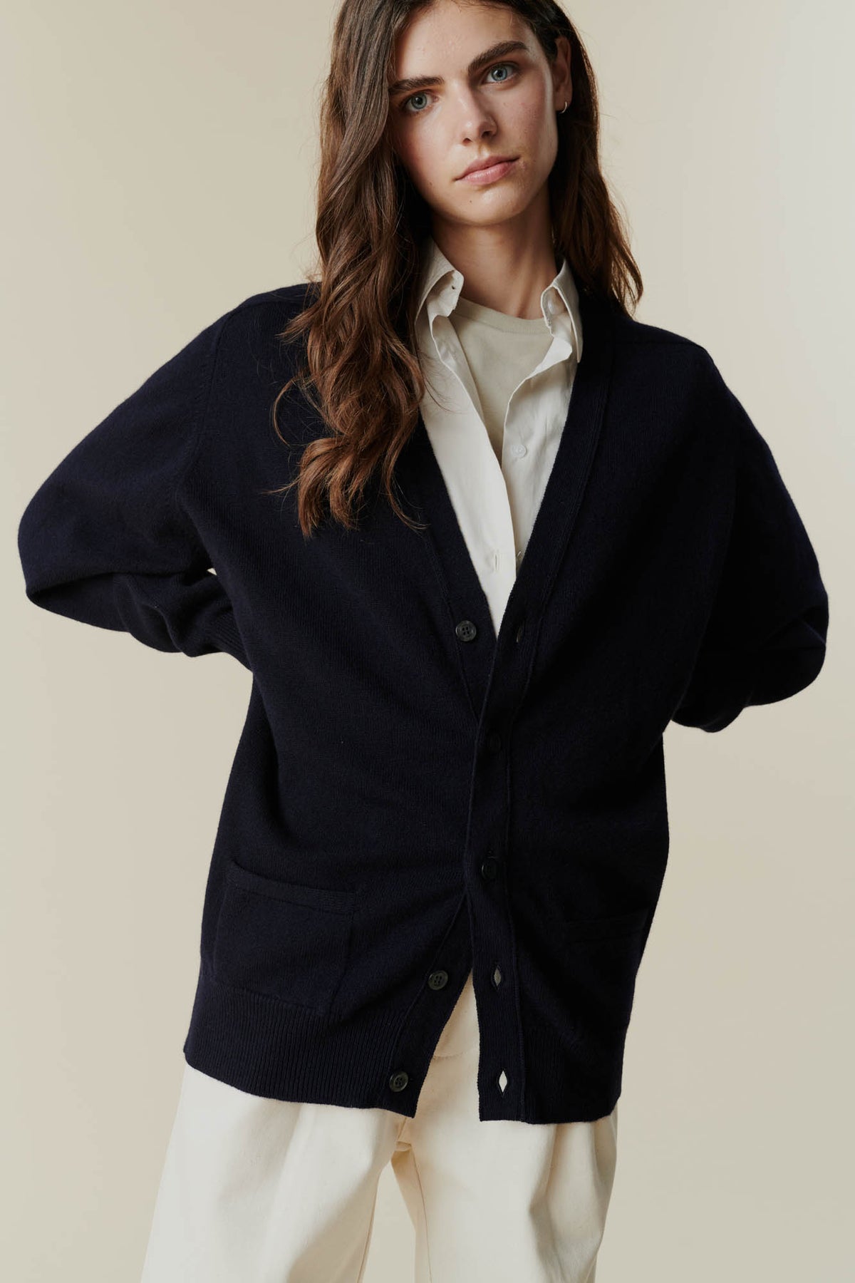 Brunette female wearing unbuttoned lambswool v neck cardigan