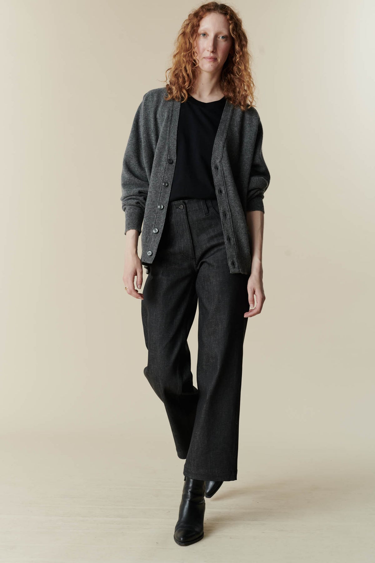 Full body image of Female wearing v neck cardigan in charcoal