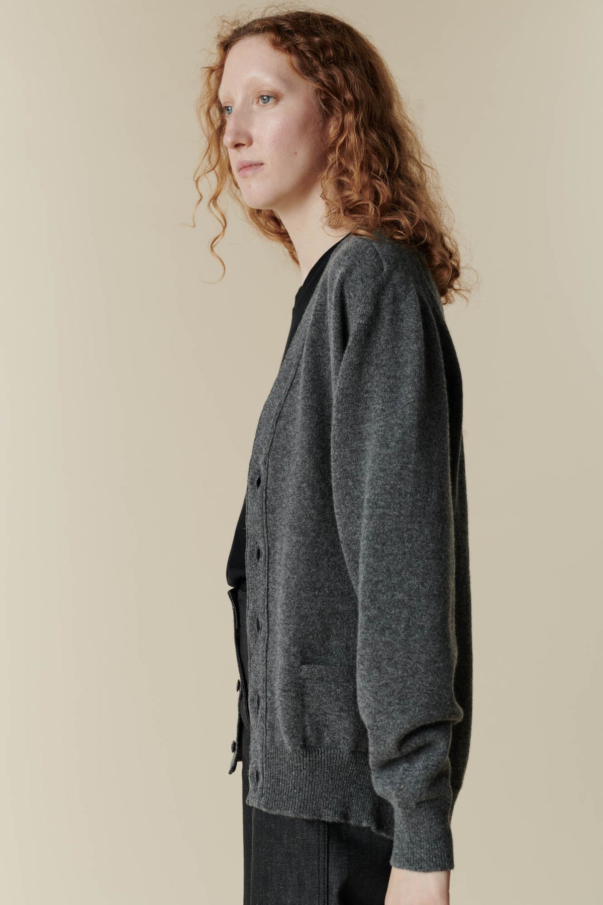 Image of side of female wearing v neck cardigan in charcoal