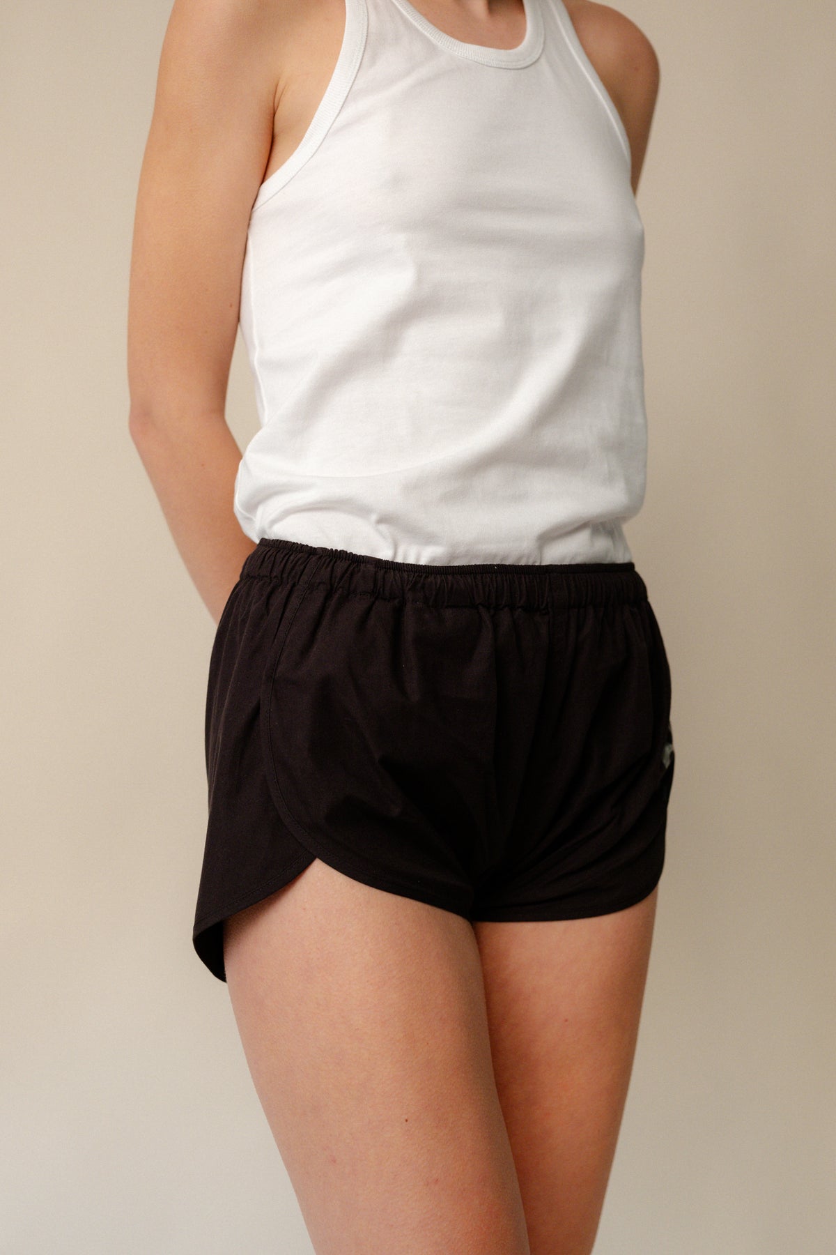 Image of white female thigh up to shoulder wearing lightweight running short plastic free in black