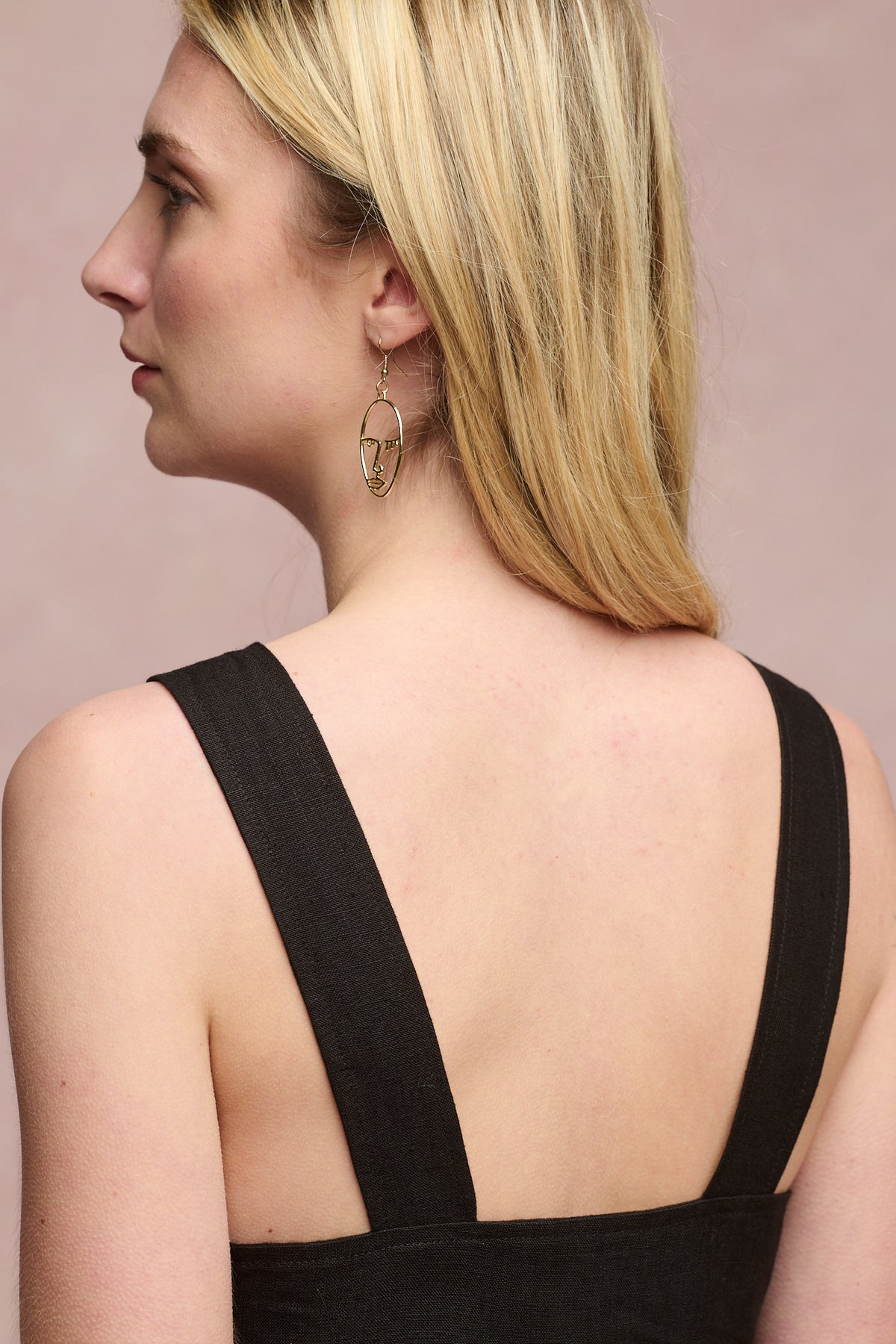 
            Back of shoulders of female wearing sun dress in black
