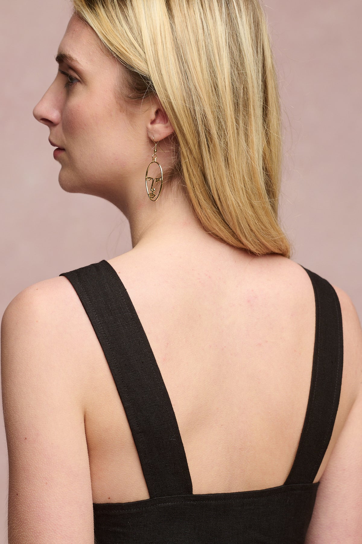 Back of shoulders of female wearing sun dress in black