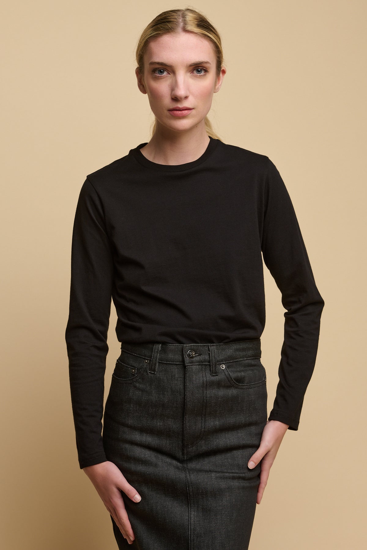 Female wearing long sleeve t shirt in black tucked into Charlie denim maxi skirt in black