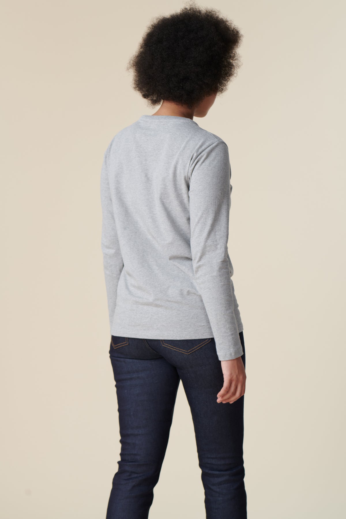Back image of female wearing long sleeve t-shirt in grey marl
