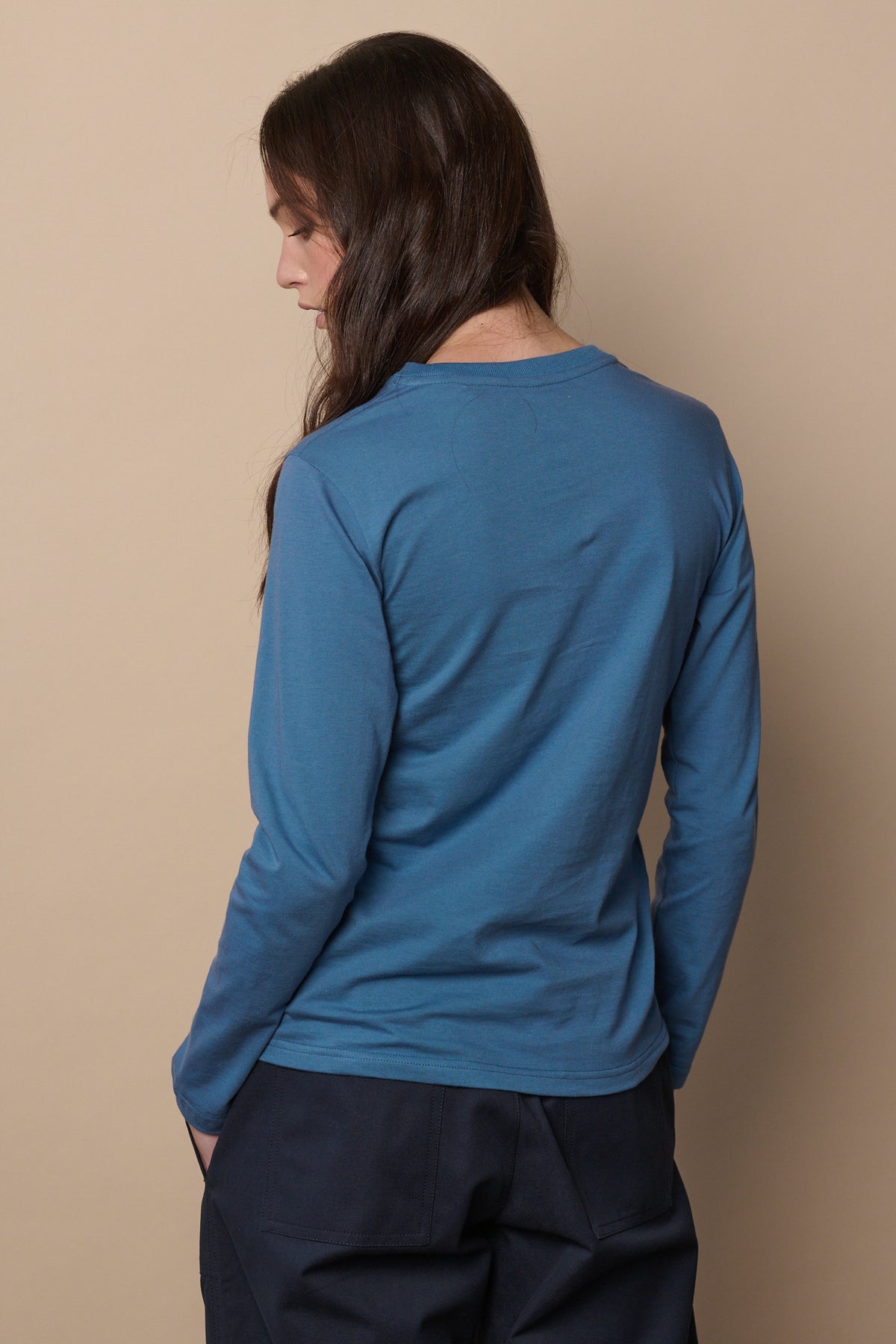 Thigh up image of the back of long sleeve t shirt in raf blue