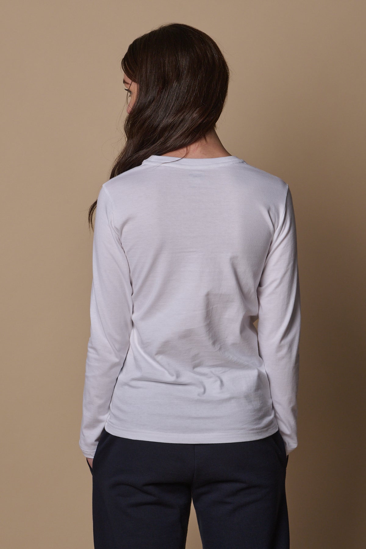 Back of female wearing long sleeve t shirt in white