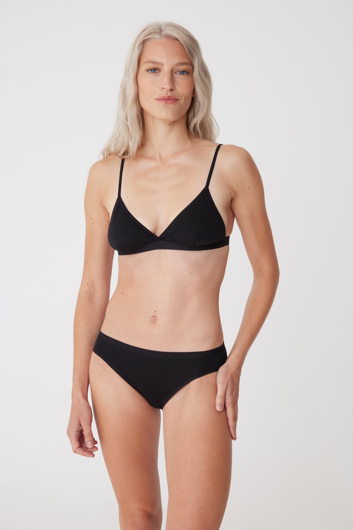 Blonde, white female wearing low rise brief in black
