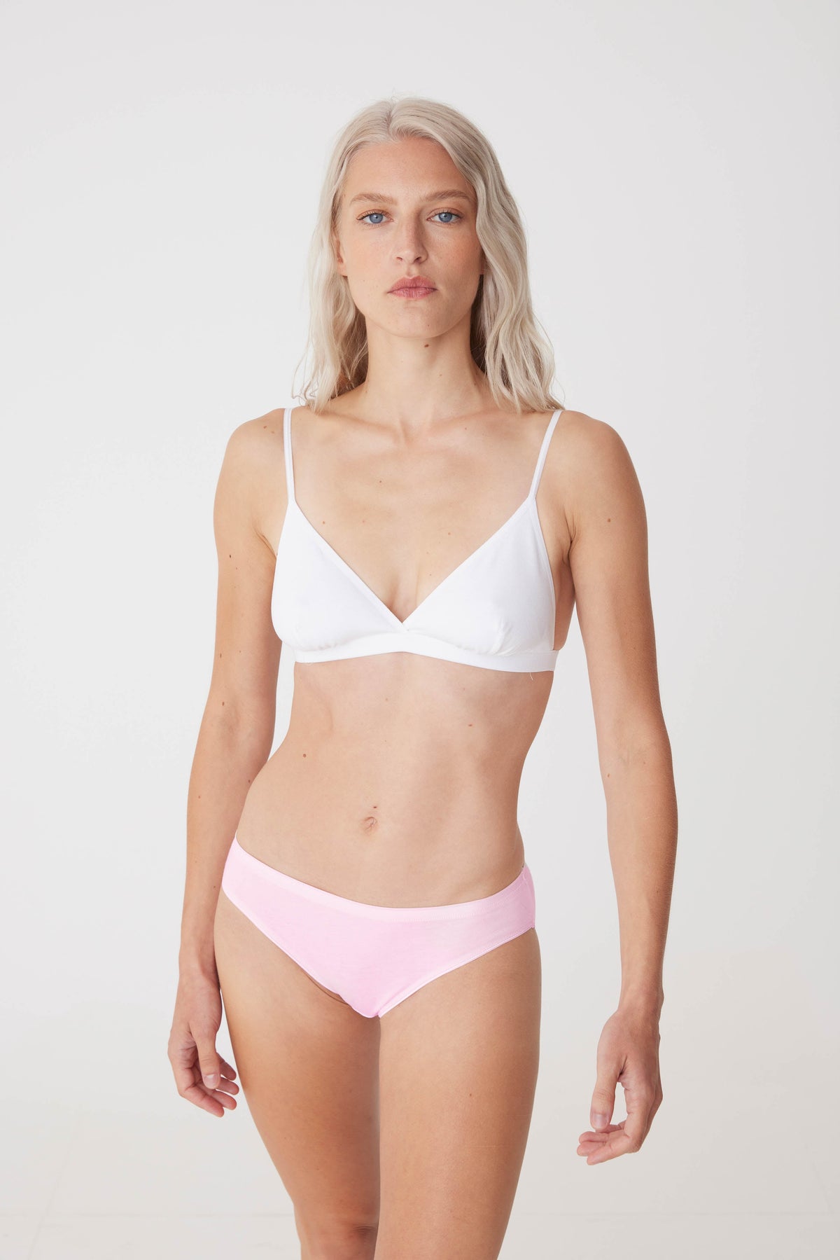 white female wearing soft pink low rise brief