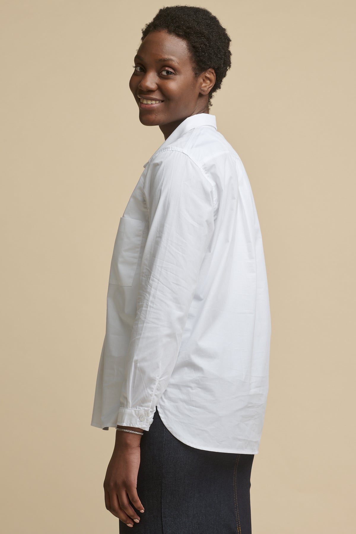 
            Thigh up image of the back of female wearing Olivia half placket lightweight cotton shirt in white