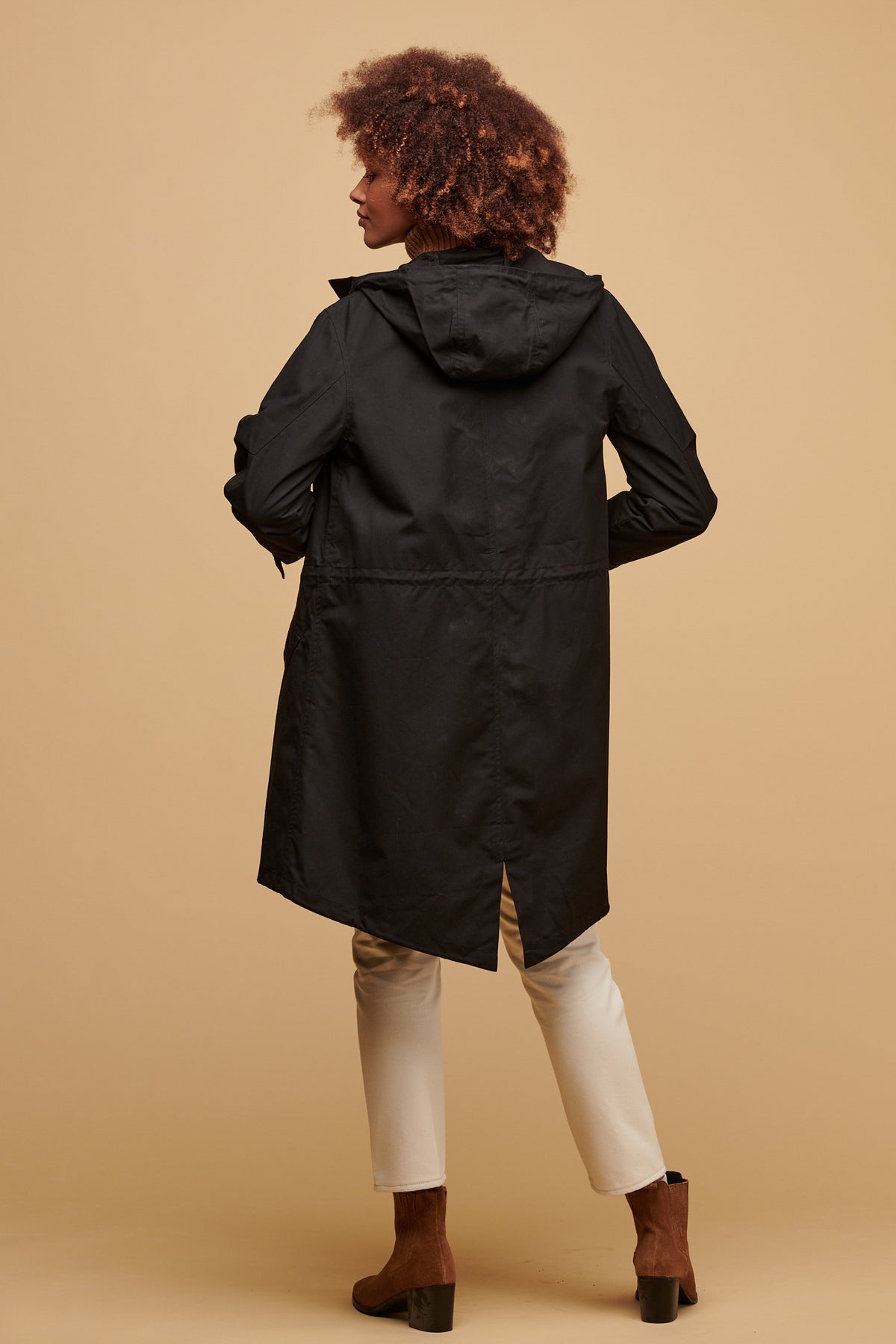 
            The back of female wearing women&#39;s parka coat in black worn with gloria jean in ecru 