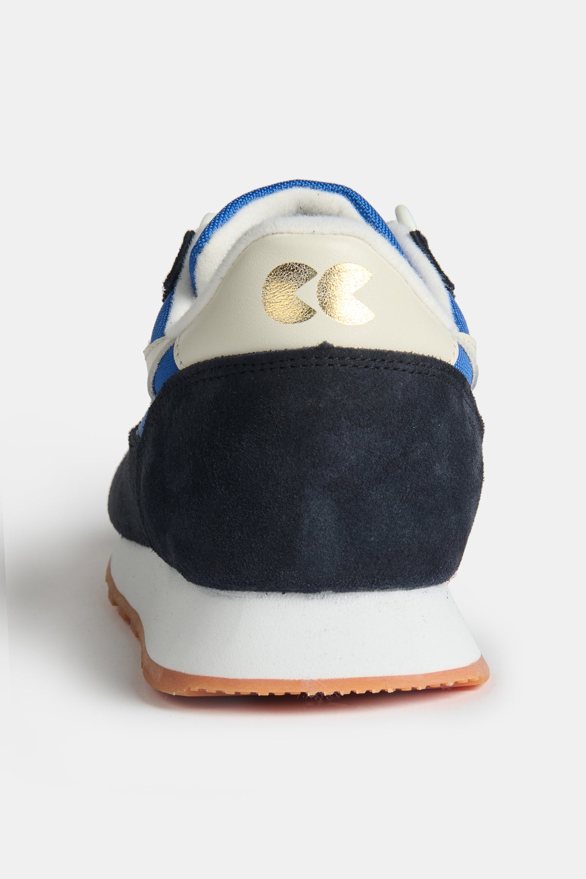 The navy and white heel of women's Parlick style Trainer in blue/ navy/ off white with gold CC foil logo