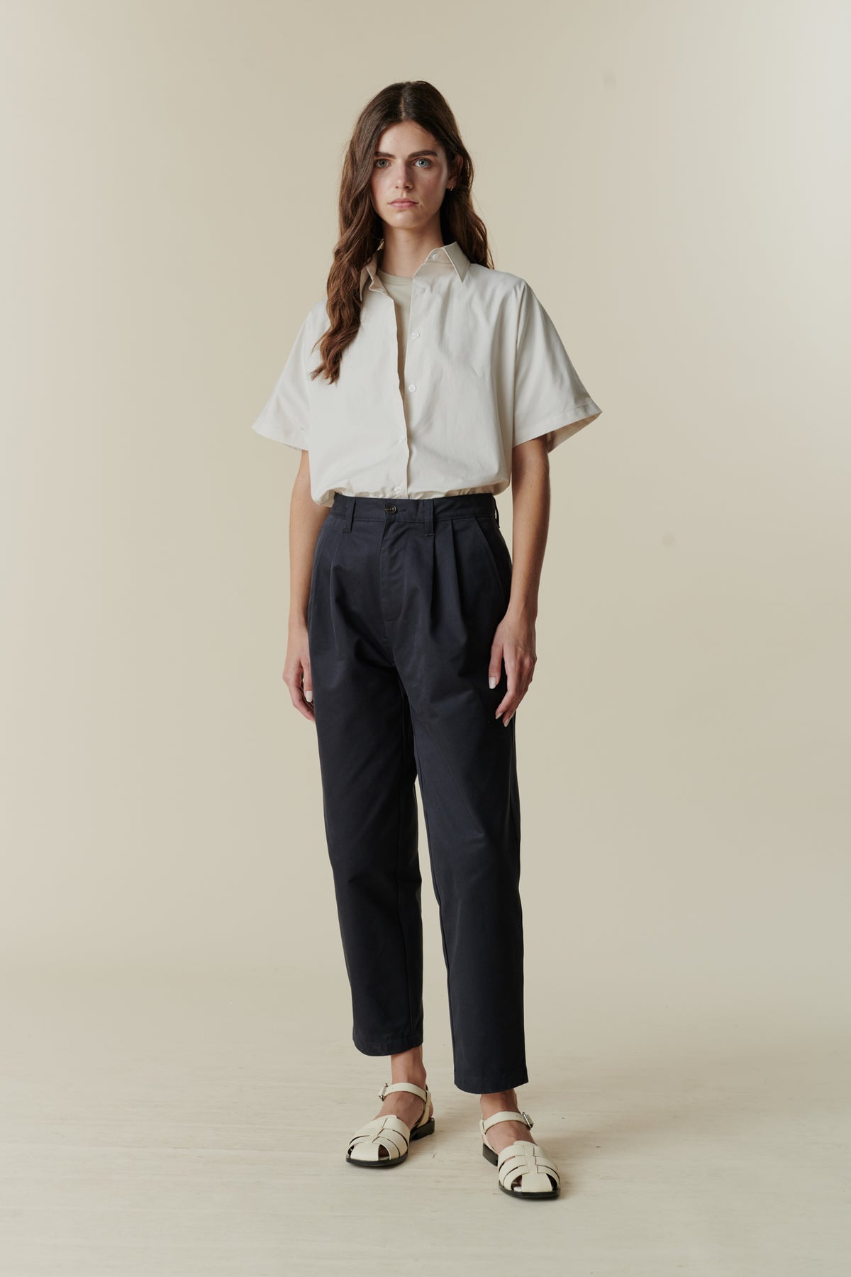 Female wearing pleated jeans in navy