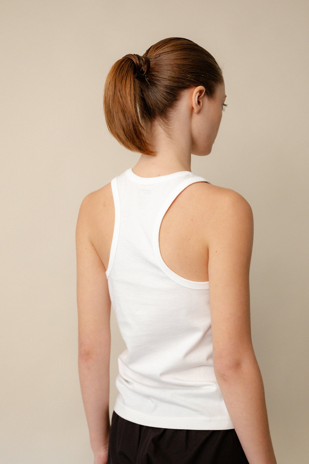 Back of white racer back vest plastic free
