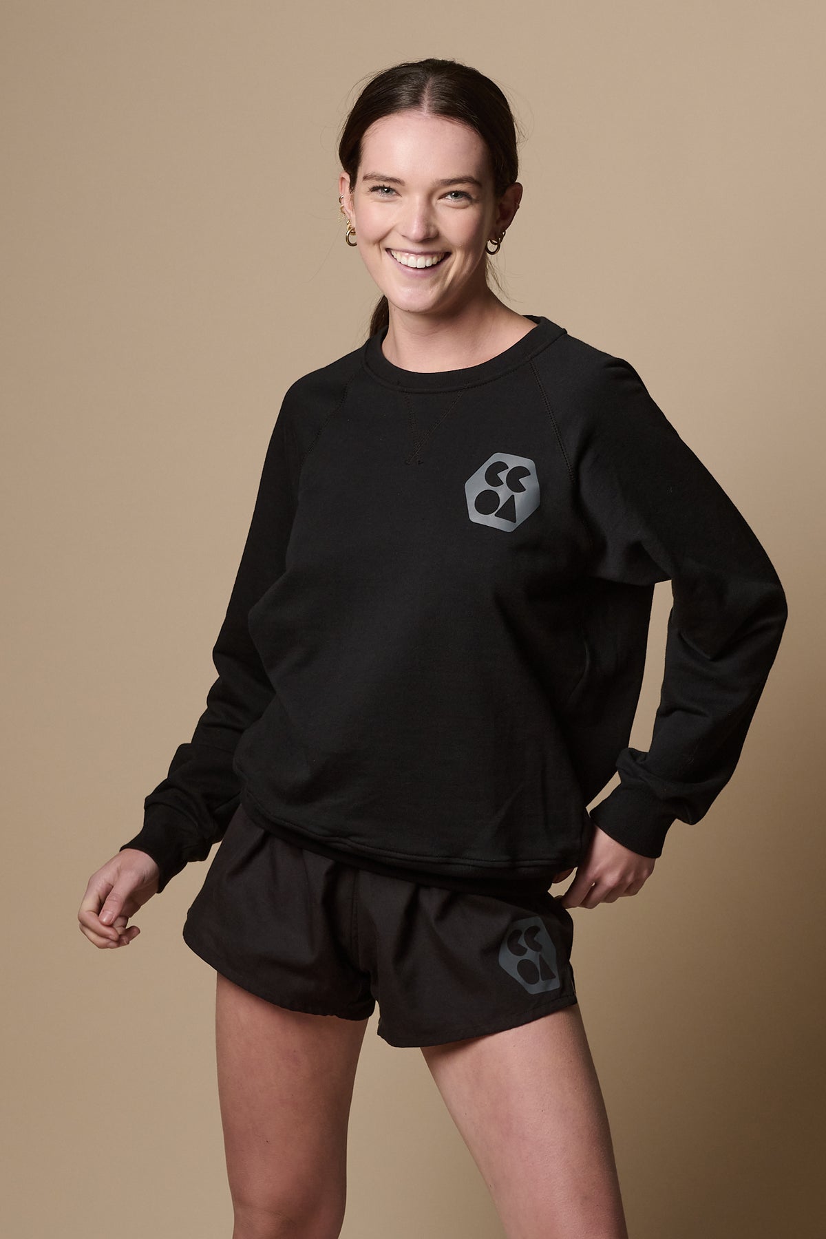 Smiley female wearing raglan sweatshirt plastic free in black
